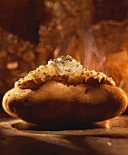 A Steaming Baked Potato with Sour Cream and Chives