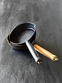 Small pans on a black surface