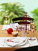 A Christmas place setting with champagne glasses