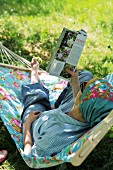 Shady spot in garden - woman reading in hammock