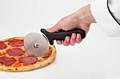 A pizza being cut