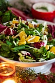 A colourful mixed leaf salad with oranges for Christmas dinner (Sweden)