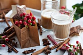 St. John's wort in a paper bag, a chai tea, cinnamon sticks and star anise