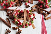 Small wreath of St. John's wort berries with cinnamon sticks, star anise and lettering
