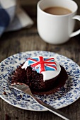 A Union Jack cupcake with a bite take out (Great Britain)