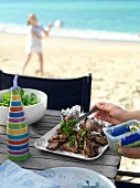 Grilled lamb chops with mint sauce on the beach