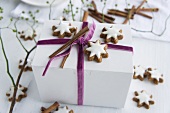 Cinnamon stars on a gift box tied with a velvet ribbon