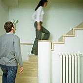 A young man and a young woman going upstairs
