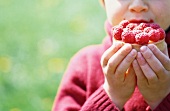 A child eating a raspberry tartlet