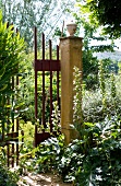 Simple iron gate leading from garden