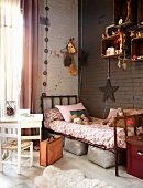 Vintage bed in corner of child's bedroom with toys in shelving modules on brown wall