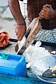An Indian street vendor preparing potato chips