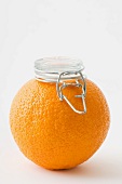 Fresh orange with canning lid on top of it