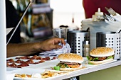 Hamburgers freshly prepared by cook waiting to be served to customers