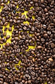 Coffee beans on a yellow surface
