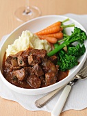 Beef goulash with mashed potatoes and vegetables