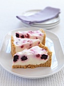Three slices of cheese cake with berries