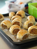 Sausage rolls on a baking tray