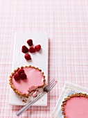 A raspberry tartlet with a bite taken out