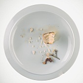 The remains of fish on a plate (seen from above)