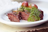Steak with Fresh Dill and Potato on a White Plate