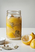 Preserved Lemons in a Glass Jar with Salt, Cardomom Pods and Bay Leaves