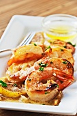 Shrimp Scampi on a Dish with Lemon; Butter Dipping Sauce