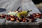 Fresh edible chestnuts on a wooden table