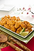 General Tso's Chicken on a Serving Platter with Lime Wedges
