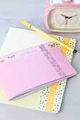 Notebook or diary decorated with tape, romantic retro alarm clock and felt-tip pen