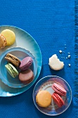 Colorful Macaroons on Plates; From Above; One with a Bite Taken Out