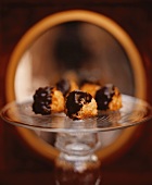 Chocolate Dipped Macaroons on a Glass Pedestal Dish