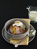 Baked lemon and coconut pudding with vanilla ice cream