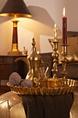 Arabian tea service and gilt candlesticks on tray in living room