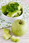 Sliced cucumber and a green apple