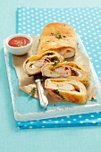 Pizza strudel with ham and cheese