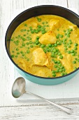 Chicken breast in curry sauce with peas