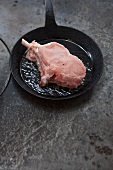 A veal chop in a pan