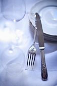 Antique cutlery, plates and wine glasses