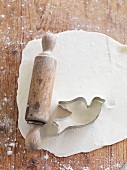 Biscuits with a dove-shaped cutter and a rolling pin