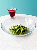 Edamame with Olive Oil and Sesame Seeds; Glass of Cranberry Juice