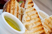 Grilled Bread Slices with a Small Bowl of Olive Oil