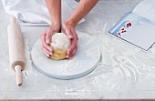 Pasta dough being shaped into a ball