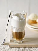 Coffee with milk foam in a glass
