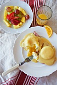 Eggs Benedict with Fruit Salad and Orange Juice; From Above