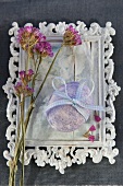 Easter egg with ribbon bow on white-painted vintage picture frame