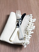 A knife and fork on a napkin
