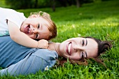 Mother and toddler lying on lawn