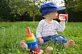 Baby drinking juice in garden