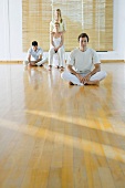 Four adults in various postures in wellness center